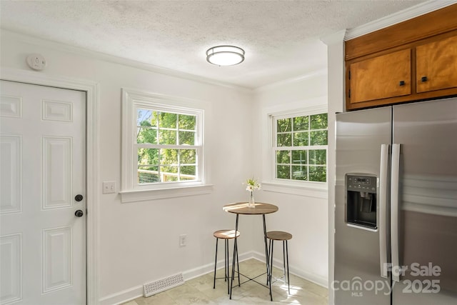 302 White St, Morganton, NC 28655 - kitchen featuring stainless steel refrigerator with ice dispenser, brown cabinets, crown molding, a textured ceiling, and light tile patterned floors