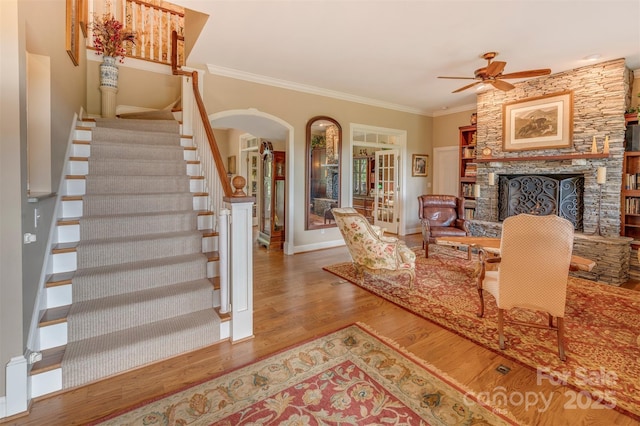 94 Spruce Hill Dr, Hendersonville, NC 28792 - living room featuring wood finished floors, stairway, ceiling fan, crown molding, and arched walkways
