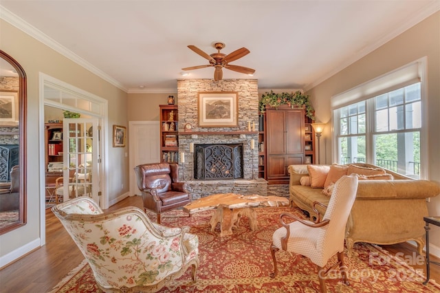 94 Spruce Hill Dr, Hendersonville, NC 28792 - living room with crown molding, wood finished floors, ceiling fan, and a stone fireplace