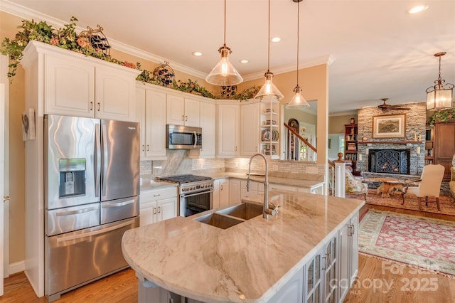 94 Spruce Hill Dr, Hendersonville, NC 28792 - kitchen featuring stainless steel appliances, light wood finished floors, backsplash, crown molding, and light stone counters