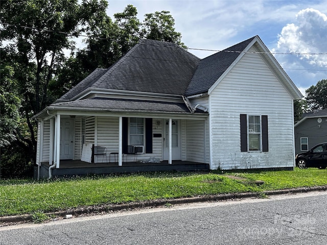 128 Pine St, Shelby, NC 28152 - view of front facade with covered porch, roof with shingles, a front lawn, and cooling unit