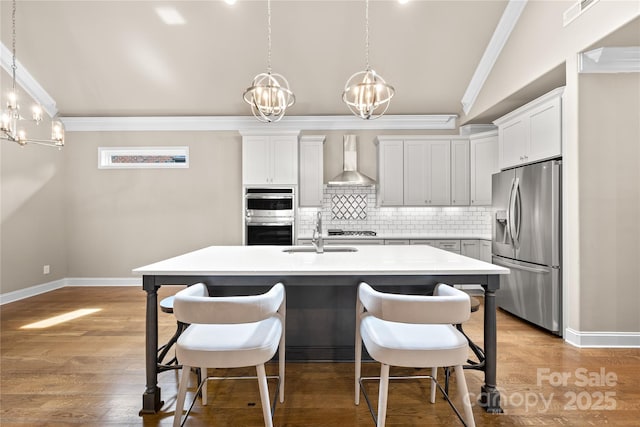 6107 Gold Springs Way, Denver, NC 28037 - kitchen with stainless steel appliances, wall chimney exhaust hood, a chandelier, crown molding, and light countertops