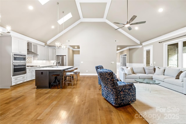6107 Gold Springs Way, Denver, NC 28037 - living area with high vaulted ceiling, a skylight, light wood-type flooring, ceiling fan, and a chandelier