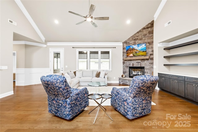 6107 Gold Springs Way, Denver, NC 28037 - living area featuring a ceiling fan, a stone fireplace, wood finished floors, high vaulted ceiling, and ornamental molding