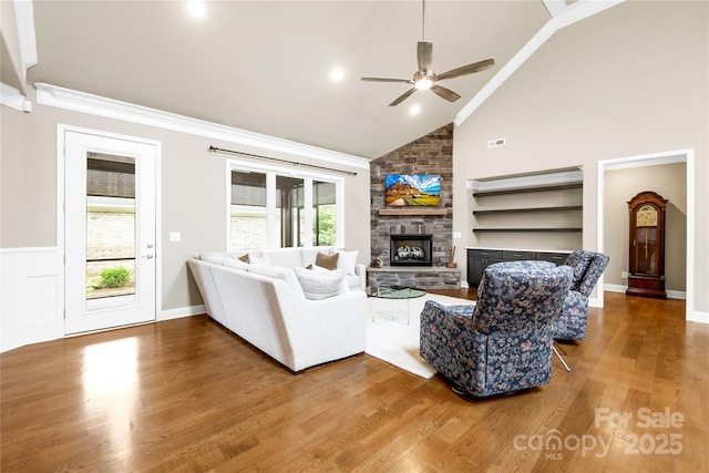6107 Gold Springs Way, Denver, NC 28037 - living area with a ceiling fan, wood finished floors, a stone fireplace, ornamental molding, and high vaulted ceiling