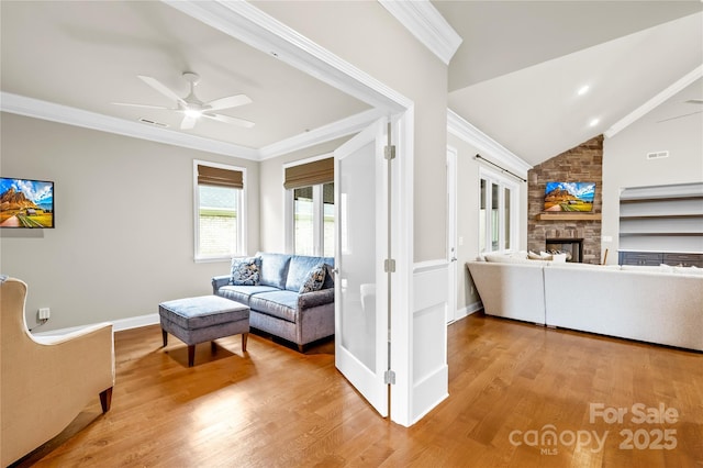 6107 Gold Springs Way, Denver, NC 28037 - living room with light wood-style flooring, a fireplace, ceiling fan, ornamental molding, and vaulted ceiling