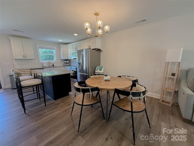 103 Springway Dr, Kannapolis, NC 28081 - dining area featuring light wood-type flooring, a chandelier, and recessed lighting