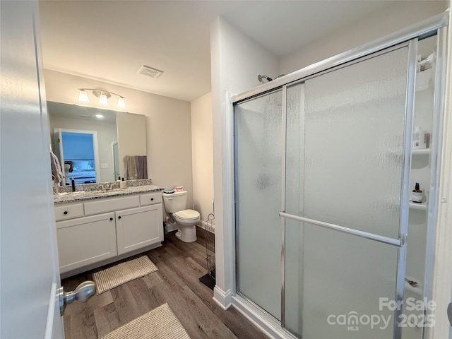 103 Springway Dr, Kannapolis, NC 28081 - bathroom featuring wood finished floors, vanity, and a stall shower