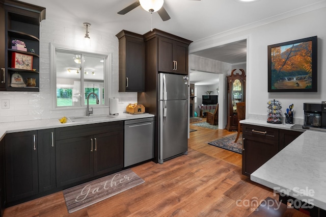 4 Sourwood Ln E, Asheville, NC 28805 - kitchen with stainless steel appliances, ceiling fan, light countertops, decorative backsplash, and ornamental molding