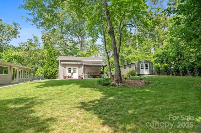 4 Sourwood Ln E, Asheville, NC 28805 - view of green lawn with an outbuilding and view of wooded area