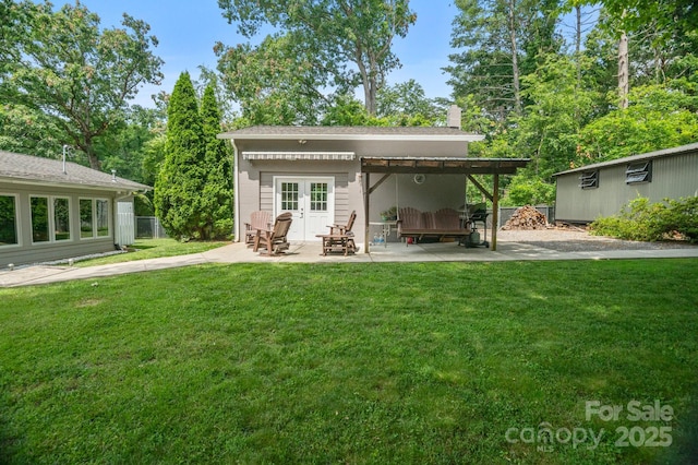 4 Sourwood Ln E, Asheville, NC 28805 - rear view of house featuring french doors, a patio area, and a chimney