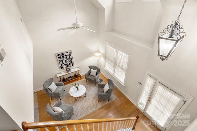 4442 Coventry Row Ct, Charlotte, NC 28270 - living area with a towering ceiling, a ceiling fan, wood finished floors, and a chandelier