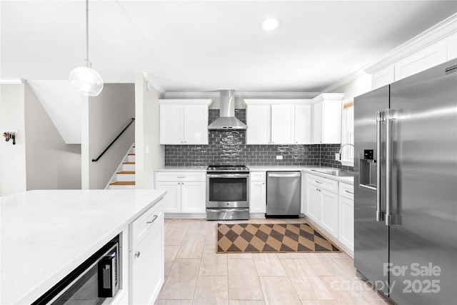2919 Dunaire Dr, Charlotte, NC 28205 - kitchen with appliances with stainless steel finishes, wall chimney range hood, light countertops, white cabinetry, and recessed lighting