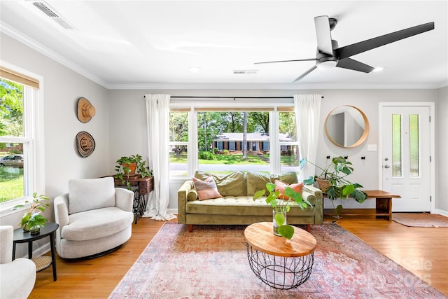 2919 Dunaire Dr, Charlotte, NC 28205 - living room featuring plenty of natural light, crown molding, ceiling fan, light wood-style floors, and recessed lighting
