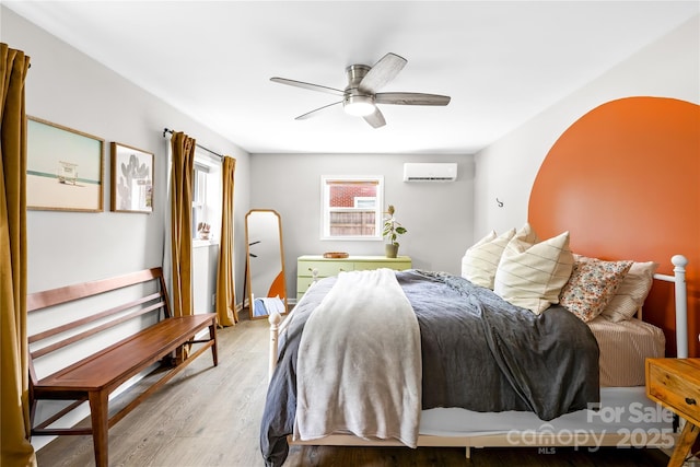 2919 Dunaire Dr, Charlotte, NC 28205 - bedroom featuring an AC wall unit, wood finished floors, and ceiling fan
