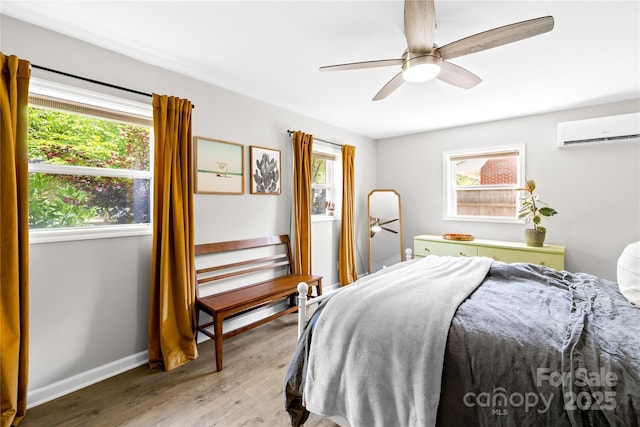 2919 Dunaire Dr, Charlotte, NC 28205 - bedroom featuring an AC wall unit, wood finished floors, and a ceiling fan