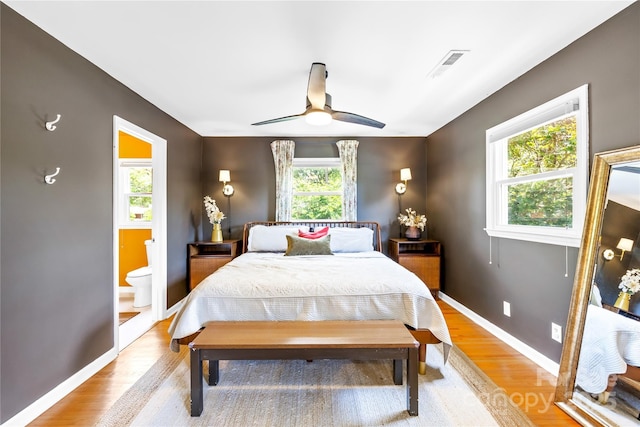 2919 Dunaire Dr, Charlotte, NC 28205 - bedroom with light wood-style flooring, ensuite bathroom, and a ceiling fan
