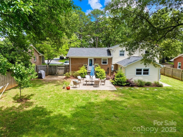 2919 Dunaire Dr, Charlotte, NC 28205 - rear view of house with a patio, a fenced backyard, brick siding, and roof with shingles