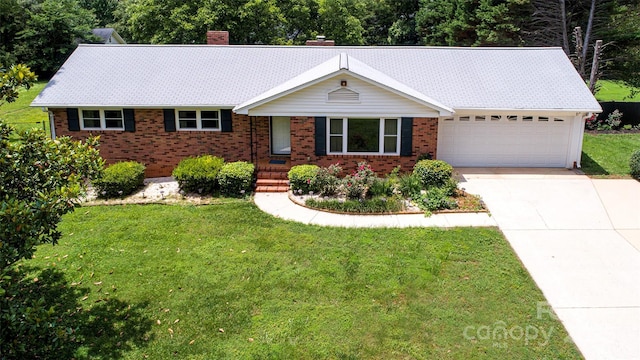 1216 Manchester Ln, Charlotte, NC 28227 - single story home with an attached garage, brick siding, a chimney, and a front yard
