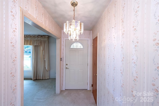 1216 Manchester Ln, Charlotte, NC 28227 - entryway featuring wallpapered walls, light carpet, and a chandelier