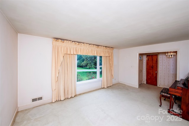 1216 Manchester Ln, Charlotte, NC 28227 - carpeted empty room with a chandelier and baseboards