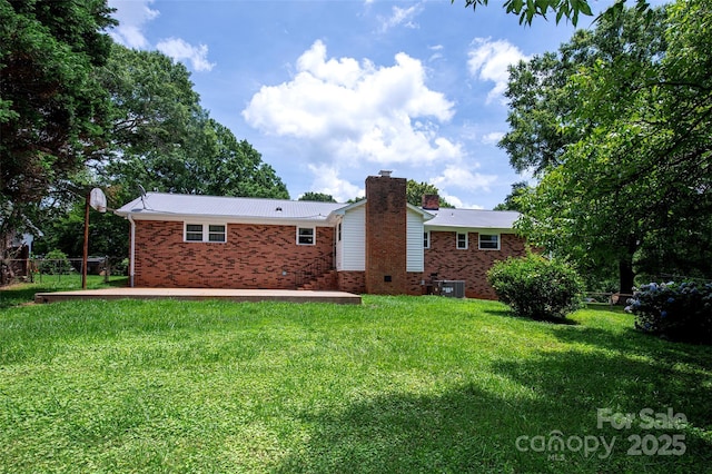 1216 Manchester Ln, Charlotte, NC 28227 - back of house with brick siding, a chimney, and a metal roof