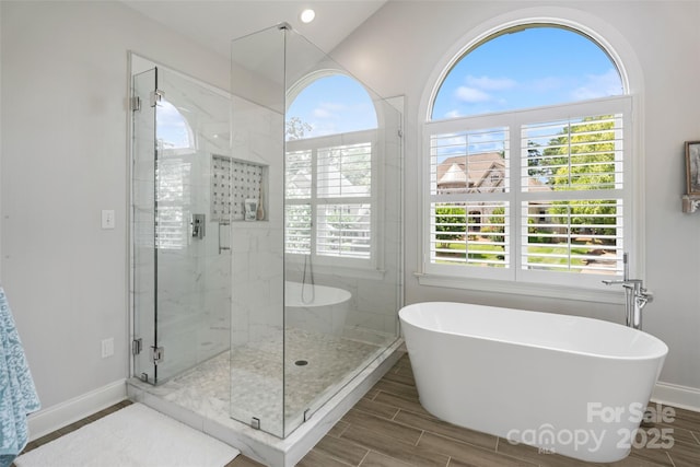 9027 Kirkley Ct, Charlotte, NC 28277 - bathroom with a freestanding tub, a stall shower, and wood finished floors