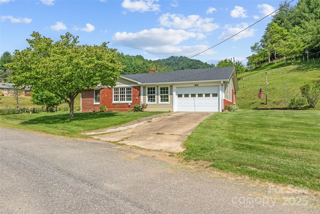 244 Carl Fox Rd, Burnsville, NC 28714 - ranch-style house with brick siding, an attached garage, driveway, and a front yard