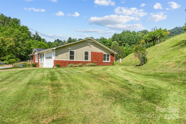 244 Carl Fox Rd, Burnsville, NC 28714 - view of home's exterior featuring brick siding, a garage, and a yard