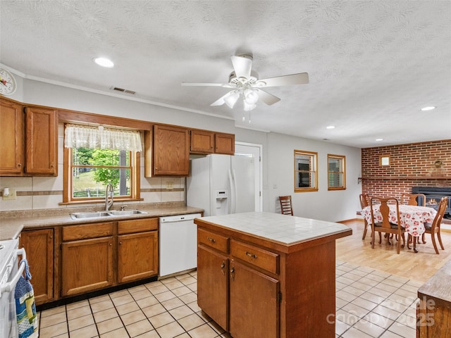 244 Carl Fox Rd, Burnsville, NC 28714 - kitchen with white appliances, brown cabinets, light tile patterned floors, a ceiling fan, and recessed lighting