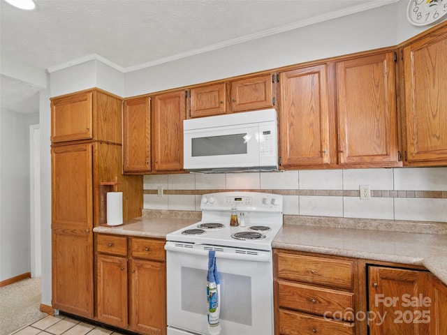 244 Carl Fox Rd, Burnsville, NC 28714 - kitchen with white appliances, brown cabinetry, light countertops, crown molding, and a textured ceiling