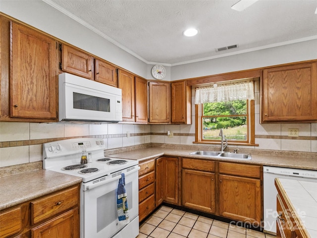 244 Carl Fox Rd, Burnsville, NC 28714 - kitchen featuring white appliances, brown cabinetry, decorative backsplash, light countertops, and ornamental molding