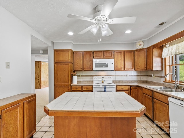 244 Carl Fox Rd, Burnsville, NC 28714 - kitchen featuring white appliances, brown cabinets, light tile patterned floors, tile countertops, and backsplash