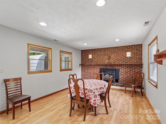 244 Carl Fox Rd, Burnsville, NC 28714 - dining room with a brick fireplace, wood finished floors, and recessed lighting