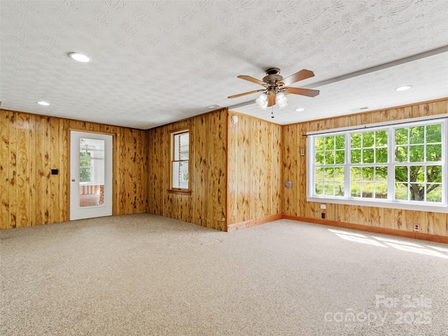 244 Carl Fox Rd, Burnsville, NC 28714 - spare room featuring carpet floors, wooden walls, a ceiling fan, and recessed lighting