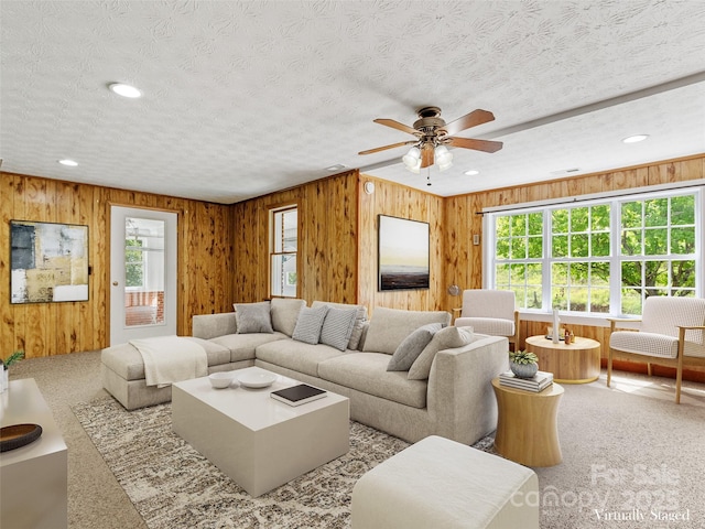 244 Carl Fox Rd, Burnsville, NC 28714 - carpeted living room featuring ceiling fan, wooden walls, a textured ceiling, and recessed lighting