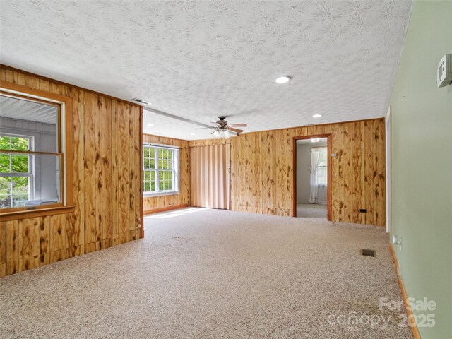 244 Carl Fox Rd, Burnsville, NC 28714 - unfurnished room with carpet flooring, a textured ceiling, ceiling fan, wood walls, and recessed lighting
