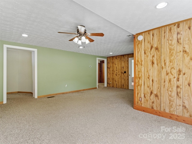 244 Carl Fox Rd, Burnsville, NC 28714 - carpeted empty room featuring ceiling fan, recessed lighting, wooden walls, and a textured ceiling