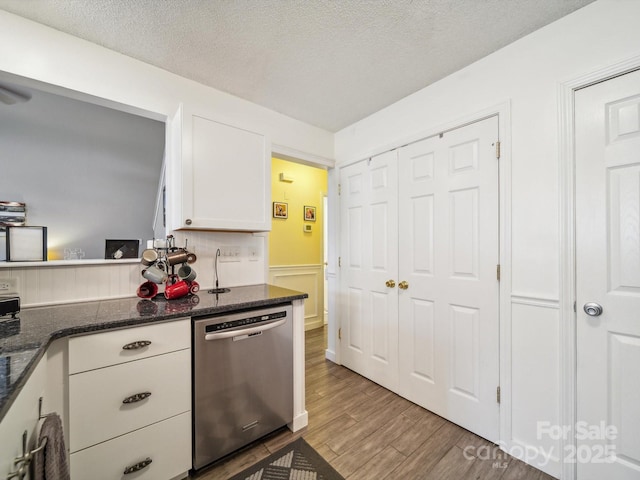 1252 Winding Path Rd, Lake Wylie, SC 29710 - kitchen with dishwasher, white cabinets, wood finished floors, a textured ceiling, and dark stone countertops