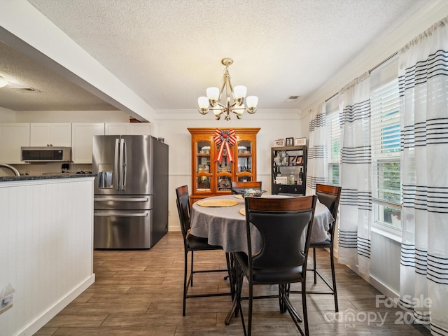 1252 Winding Path Rd, Lake Wylie, SC 29710 - dining space with a chandelier, a textured ceiling, and wood finished floors