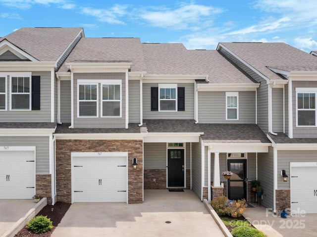 567 Big Sur Loop, Asheville, NC 28806 - townhome / multi-family property with stone siding, roof with shingles, an attached garage, and concrete driveway