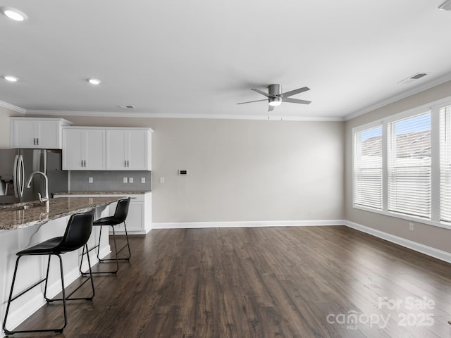 567 Big Sur Loop, Asheville, NC 28806 - kitchen with stainless steel refrigerator with ice dispenser, ornamental molding, a breakfast bar, dark wood-style floors, and a ceiling fan