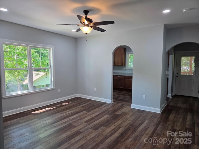 94 James St SW, Concord, NC 28025 - empty room featuring arched walkways, healthy amount of natural light, a smoke detector, and recessed lighting