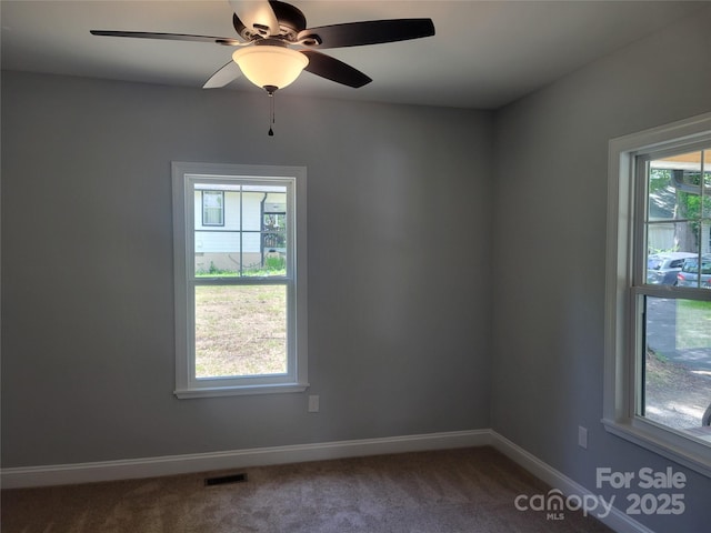 94 James St SW, Concord, NC 28025 - empty room featuring dark colored carpet and a ceiling fan