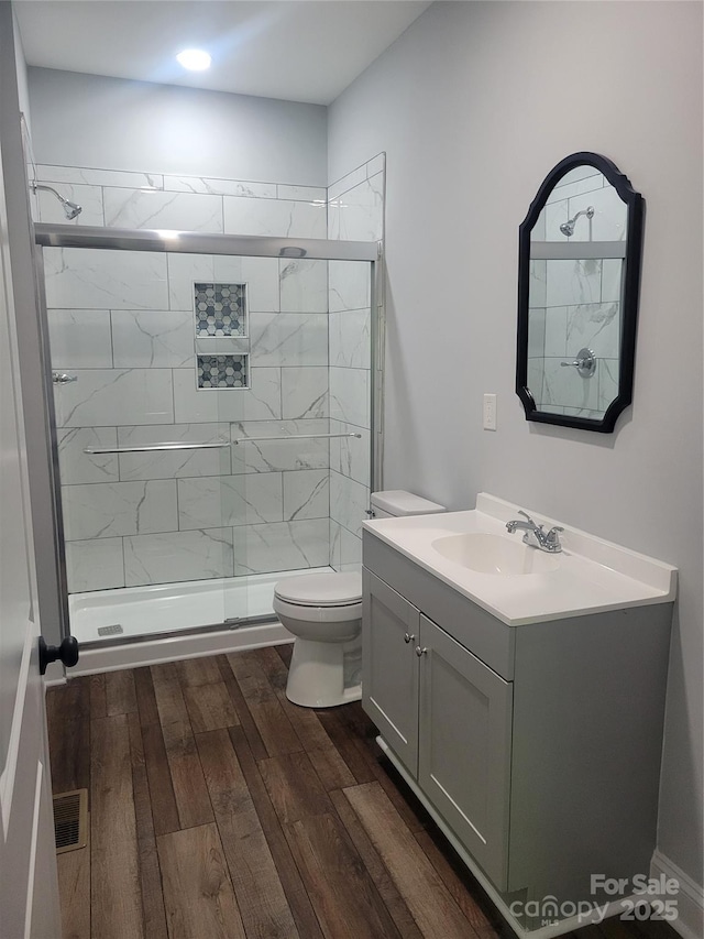 94 James St SW, Concord, NC 28025 - full bathroom featuring vanity, wood finished floors, and a stall shower