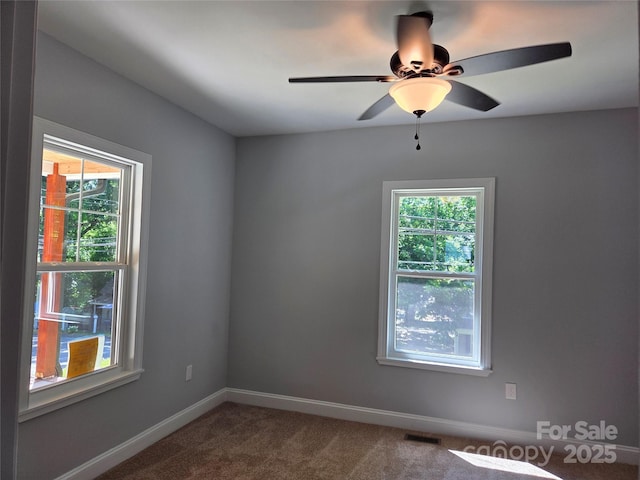 94 James St SW, Concord, NC 28025 - empty room with dark carpet and a ceiling fan