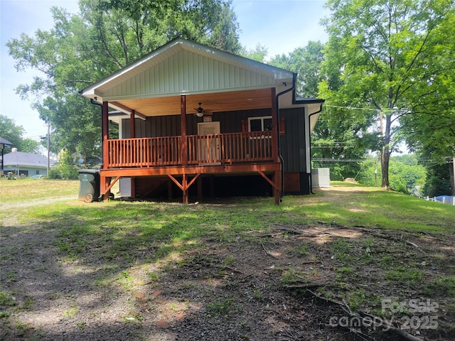 94 James St SW, Concord, NC 28025 - view of front facade with ceiling fan, a deck, and board and batten siding