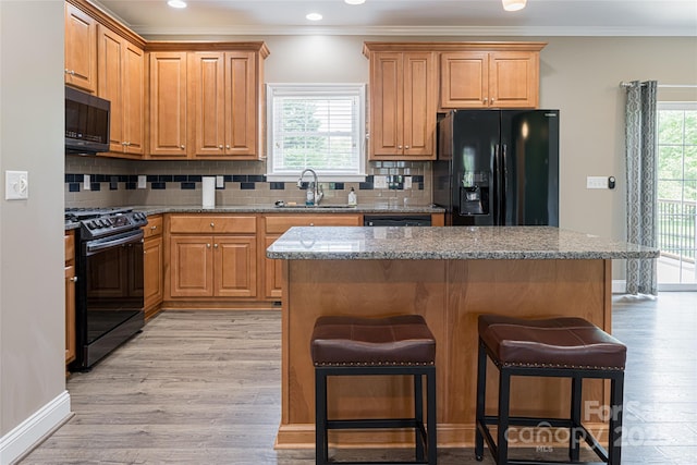 106 Beaver Dam Dr, Mills River, NC 28759 - kitchen featuring black appliances, a breakfast bar, crown molding, backsplash, and stone counters