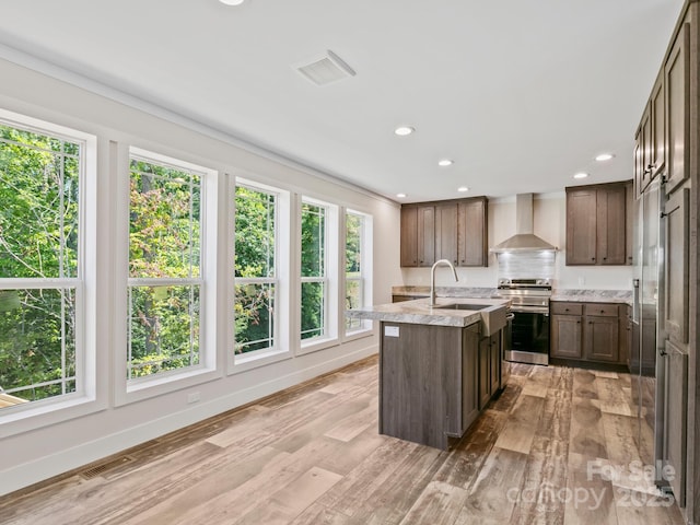 206 Walnut Branch Rd, Weaverville, NC 28787 - kitchen featuring electric range, wall chimney exhaust hood, a center island with sink, light wood-style flooring, and recessed lighting