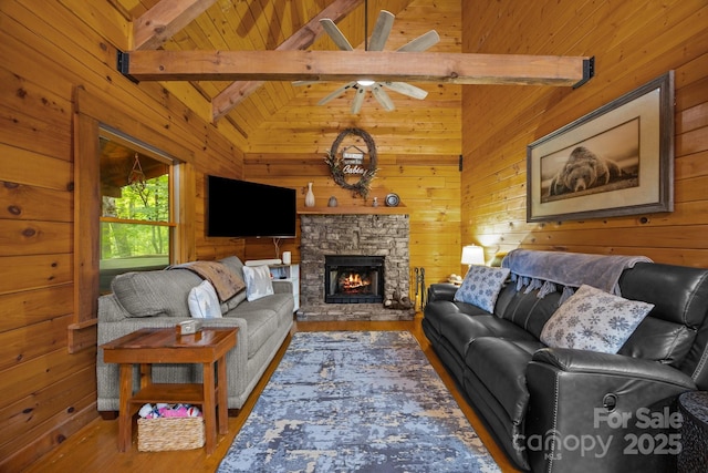 83 Log Cabin Dr, Maggie Valley, NC 28751 - living area with wood walls, wood finished floors, a ceiling fan, and a stone fireplace